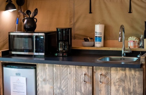 Mill Spring House | Safari Tent nestled in the woods, creek side, furnished balcony, pet friendly, sleeps 5.