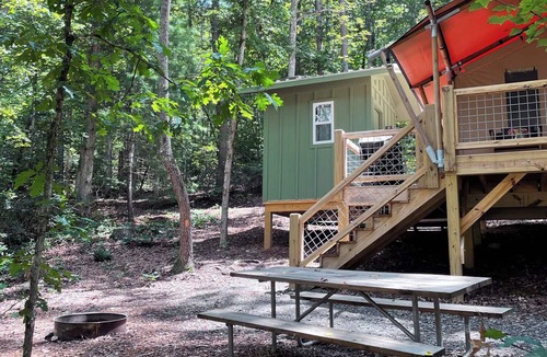 Mill Spring House | Safari Tent nestled in the woods, creek side, furnished balcony, pet friendly, sleeps 5.