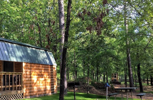 Hugo House | Small one room cabins with no bathrooms hot tub and covered picnic tables.